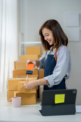 A person is using a tape dispenser to seal a box