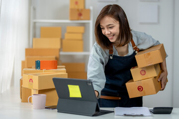 A woman is holding boxes and smiling