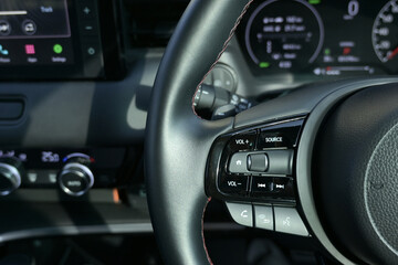 interior view of car with black leather, steering wheel with button