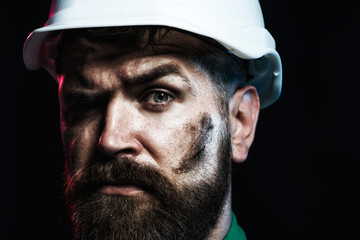 Builder man. Closeup portrait of builder in protective helmet. Hard work. Handsome engineer or...