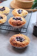 Blueberry streusel sweet bread with fresh berries and creamcheese on a wooden cutting board
