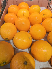 Fresh Oranges in Cardboard Box Display