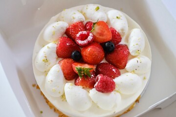 A Japanese-style strawberry shortcake with fresh cream, strawberries, raspberries and blueberries in a white cake box from Maki’s Patisserie in Sydney, Australia
