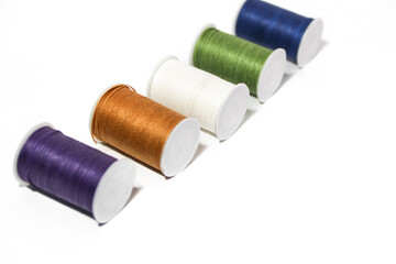 Spool of sewing thread, isolated on white background. Colored yarns used by factories in the clothing industry. Threads wound on the spool. Colored reels