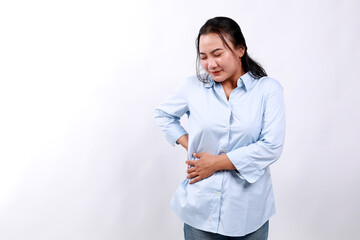 Asian woman is suffering from stomach pain in the right side with hands feeling acute pain....