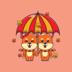 Cute couple shiba inu with umbrella at autumn season