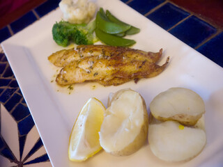 Golden Grilled sole fish served with boiled potato and vegetables, dining at Stanley village, Hong Kong