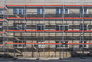 Old Residential Building Renovation Site With Scaffolding Lit By Sunlight