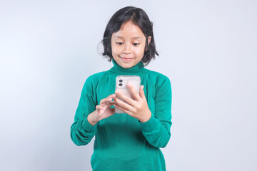 Smiling Little Girl Playing Games Using Smart Phone Isolated Grey Background