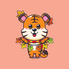 Obraz premium Cute tiger with autumn leaf decoration