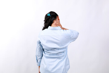 Neck pain muscle stress and strain concept. Stressed Asian woman massaging sore neck, back view....