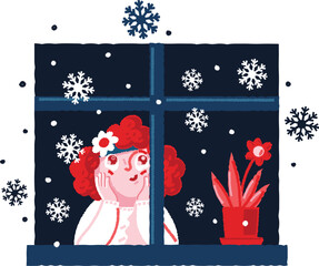 Girl is watching the snow fall from the window