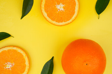 Summer fruit background concept, fresh orange slices and leaves with copy space
