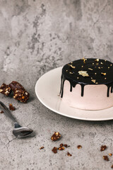 Elegance Luxury Cake Topped With Gold Serve With Chocolate Almonds With Spoon Over Grey Background