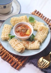 Roti Jala or Lace pancake is Indonesian traditional food served with curry dishes
