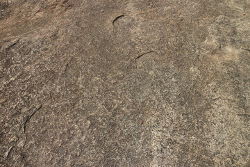 Details of sand stone texture, closeup shot of rock surface with vignette at cover and bright spot at centre, idea for background or backdrop.