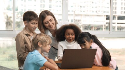 Cute african girl programing system while surround with caucasian teacher and diverse friend....
