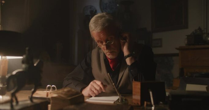 Old watchmaker alone in his office at night.