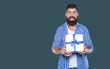 surprised mature bearded man with present box on grey background
