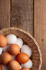 Basket of chicken eggs on a wooden table