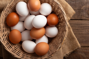 Basket of chicken eggs on a wooden table