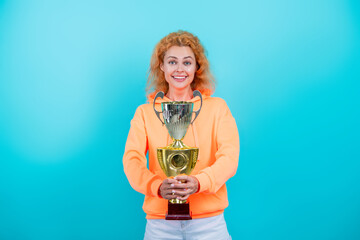 Being a true champion. Celebrating success. Woman champion isolated on blue. Sport success and victory. Woman holding champion cup. Woman winner in sport. Successful sport. Champion athlete
