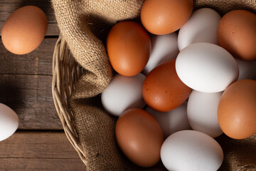 Basket of chicken eggs on a wooden table