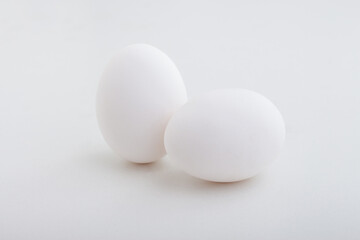 two white eggs on white background
