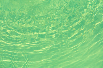 Green water with ripples on the surface. Defocus blurred transparent blue colored clear calm water...