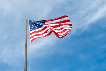 Independence day. Patriotic symbol. American Flag for Memorial Day or 4th of July. American flag waving in the wind. Flag of the USA. National waving flag of united states on blue sky. Labor day