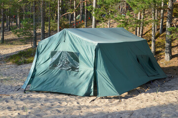 Tourist tent on sand in forest.