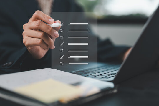 Business performance checklist, businessman using laptop doing online checklist survey, filling out digital form checklist, take an assessment, questionnaire, evaluation, online survey, online exam.