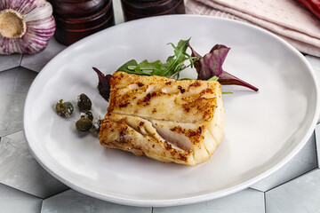 Roasted cod fish steak with salad