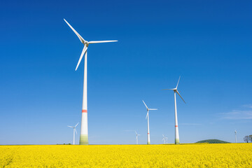 Wind turbines and a field of flowering rapeseed seen in Germany