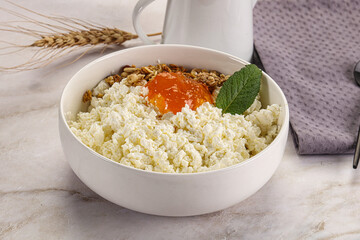 Curd with granola and orange jam