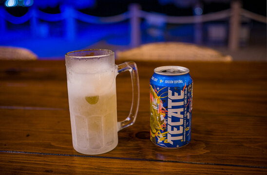 Photo of a special blue graphic edition of a Tecate light beer can next to a frosty mug on a table at the cantina at Sonoran Sky resort.