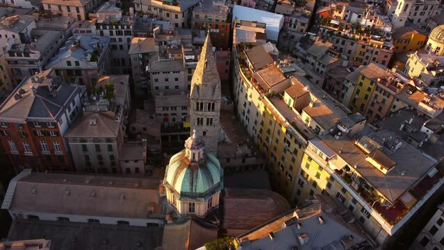 Genoa's historic center at sunset with warm light on colorful buildings, aerial view