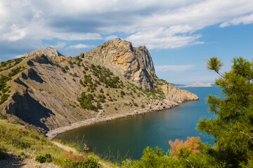 View of Mount Koba-Kaya, on the slope of which the Golitsyn trail is cut down off the coast of the Blue Bay. A popular tourist route. Crimea, Russia