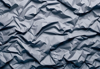 A close-up photo of crumpled gray paper