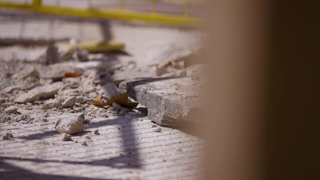 Escombros de obra en construcci&oacute;n un d&iacute;a de oto&ntilde;o con hojas de arboles. Piedras y restos de granito por la obra. 