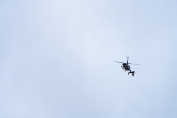 Police helicopter on the overcast sky.