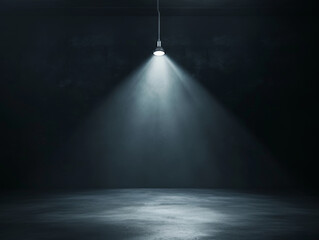 Single spotlight shining down in a dark room