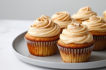 Elegant and Delicious Apple Cupcakes with a Sprinkle of Cinnamon and Cream Cheese Frosting