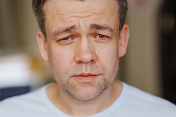 close-up. A middle-aged man is crying. men's pain and resentment. psychological support in crisis...