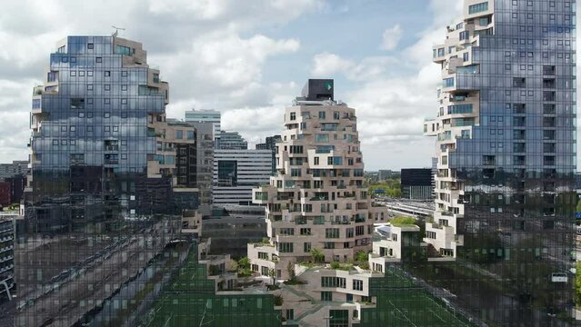 Exterior Facade Of Mixed-use Complex The Valley In Business District Of Amsterdam In Netherlands. drone pullback shot