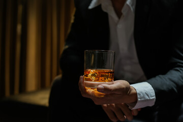 businessmen holding a glass of whiskey