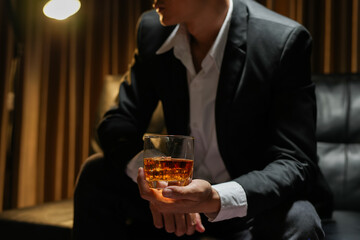 businessmen holding a glass of whiskey