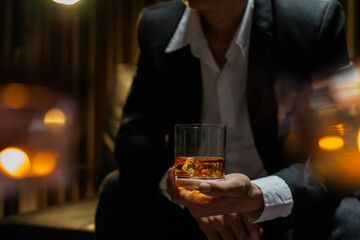 businessmen holding a glass of whiskey