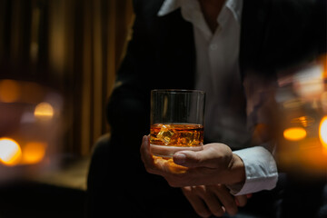 businessmen holding a glass of whiskey