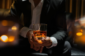 businessmen holding a glass of whiskey